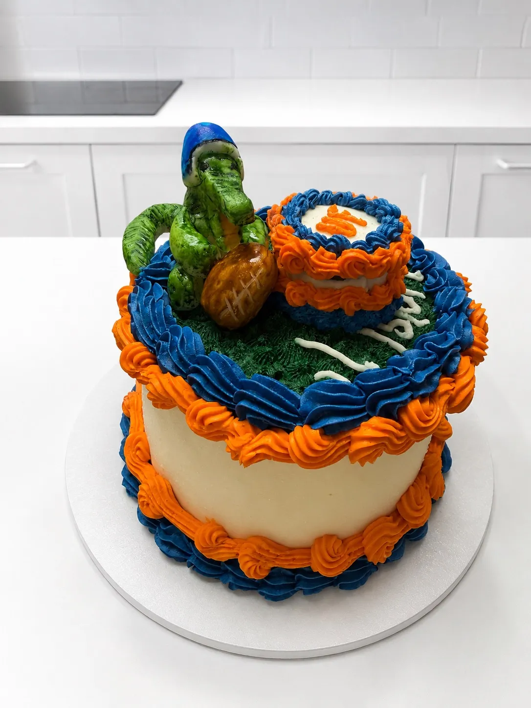 An orange and blue dinosaur birthday cake