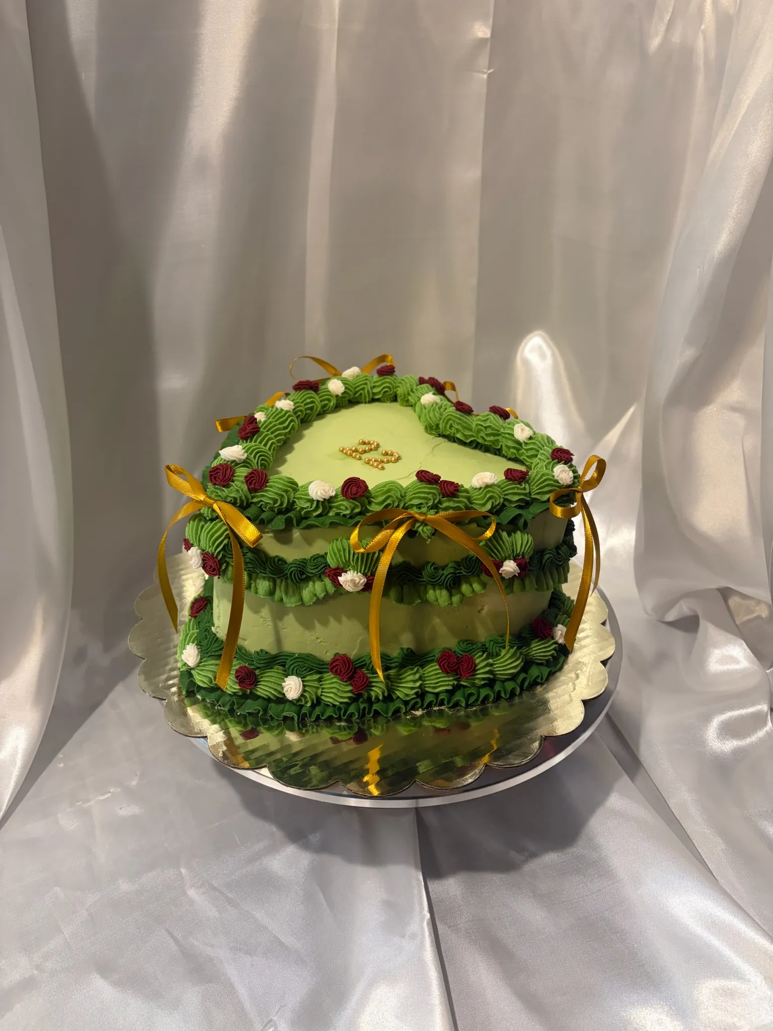 A textured cake finished with a gold ribbon