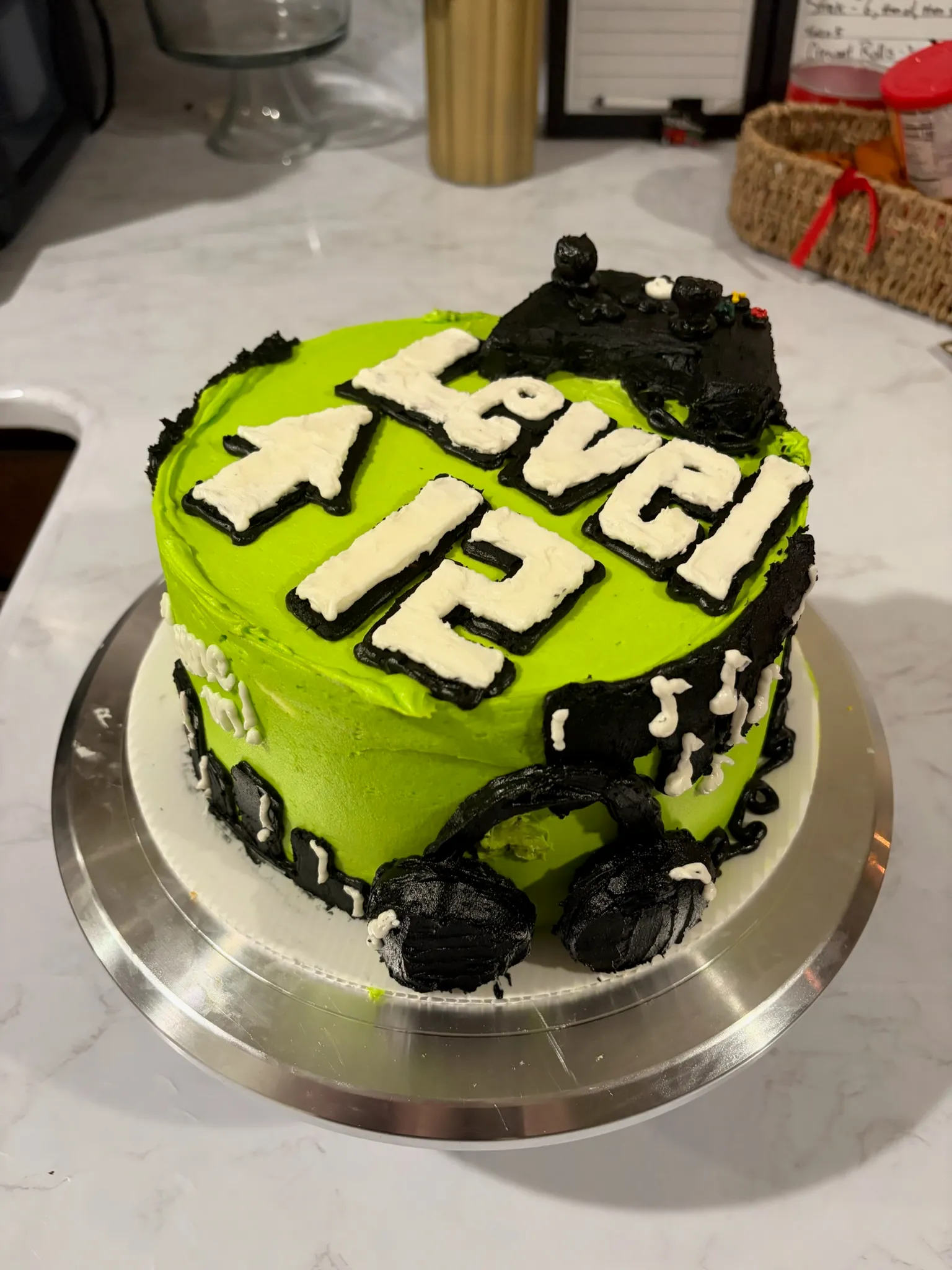 A green gaming-themed cake decorated with a controller and 'Level 12'