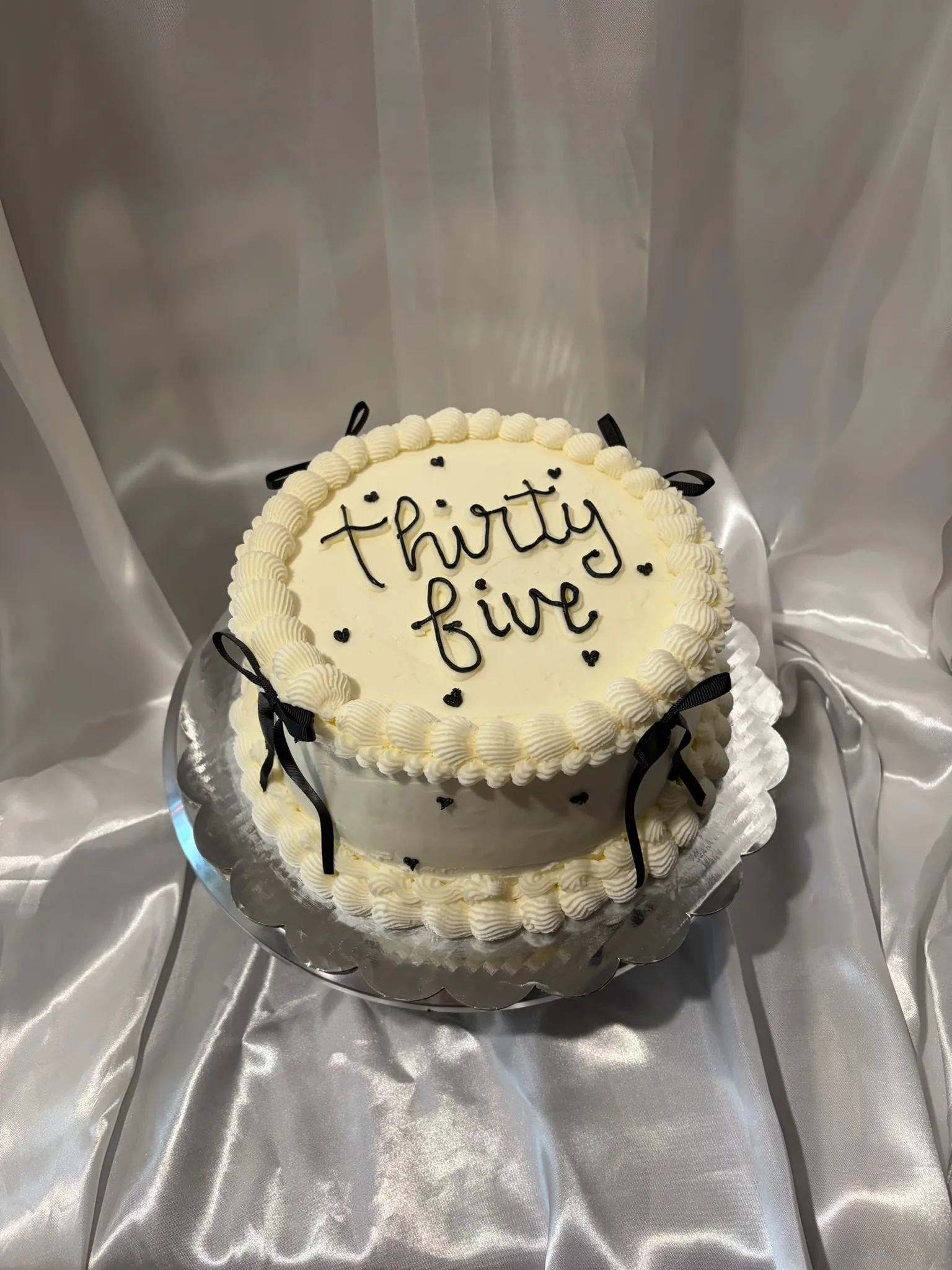 An elegant white cake finished with a satin bow