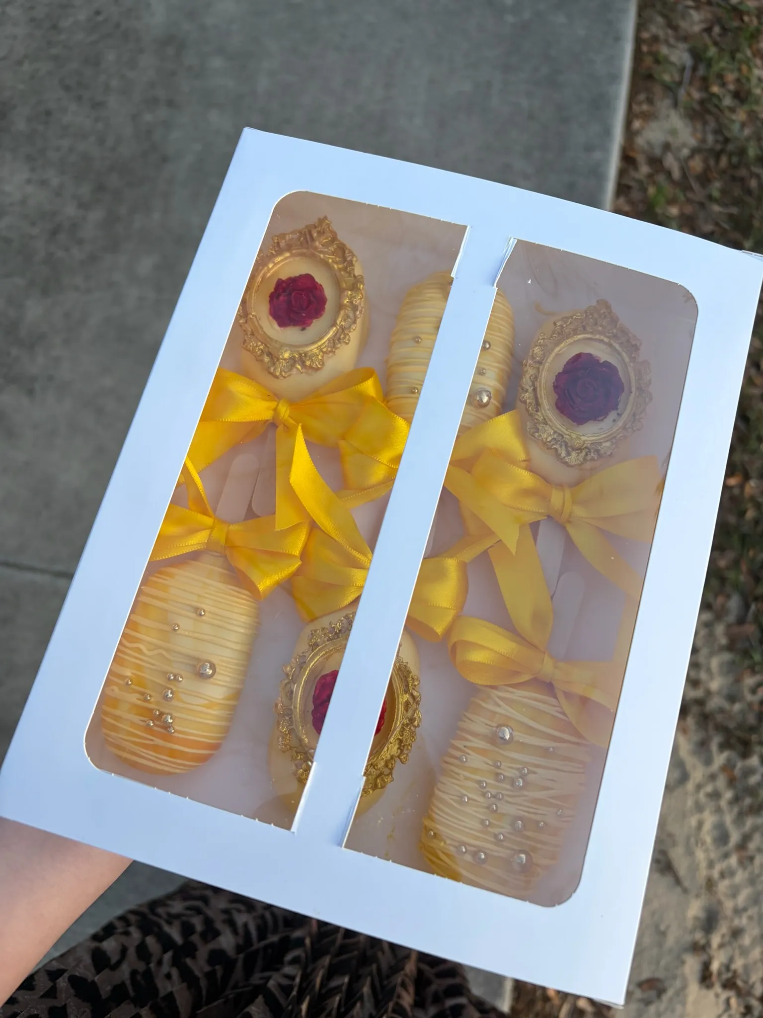 Gold and cream cake pops packaged as favors