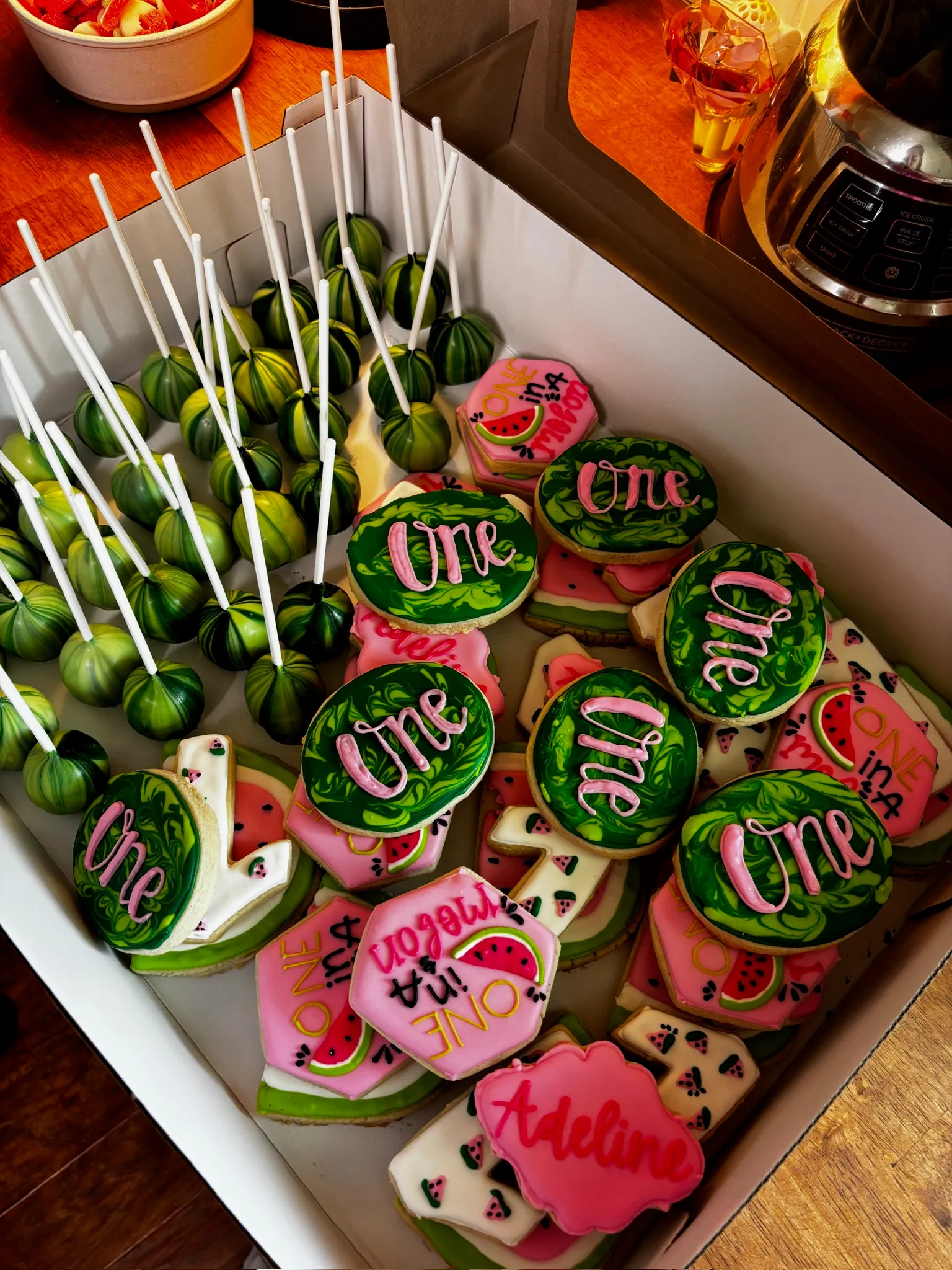 Watermelon-themed 'One' cake pops with matching cookies