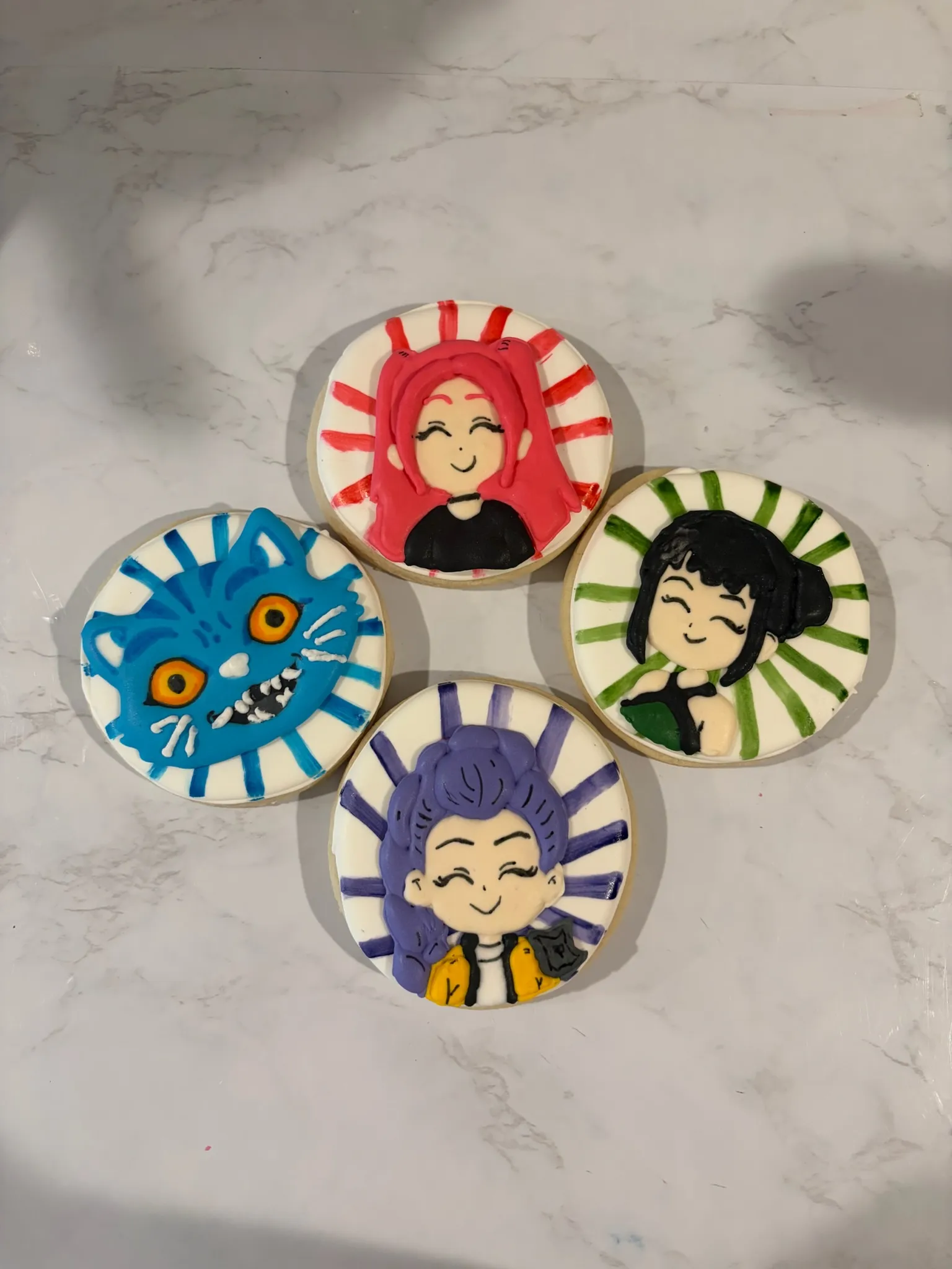 Round cookies hand-painted with cartoon character portraits