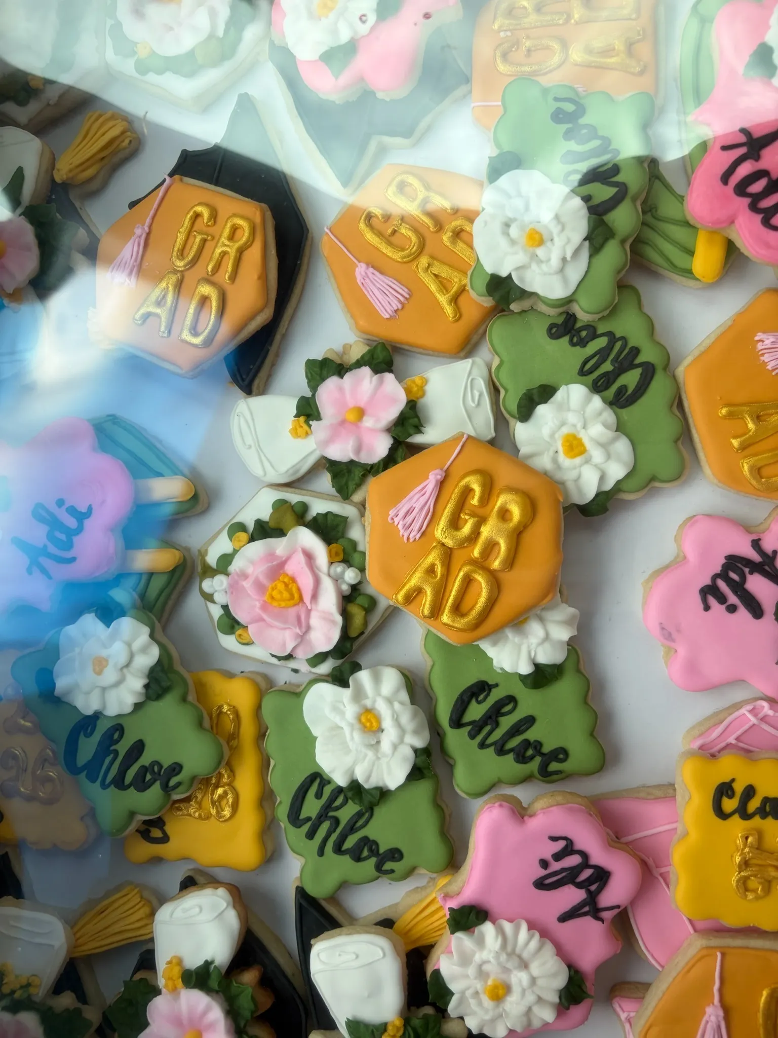 Pastel sugar cookies iced with flowers and hand-piped names