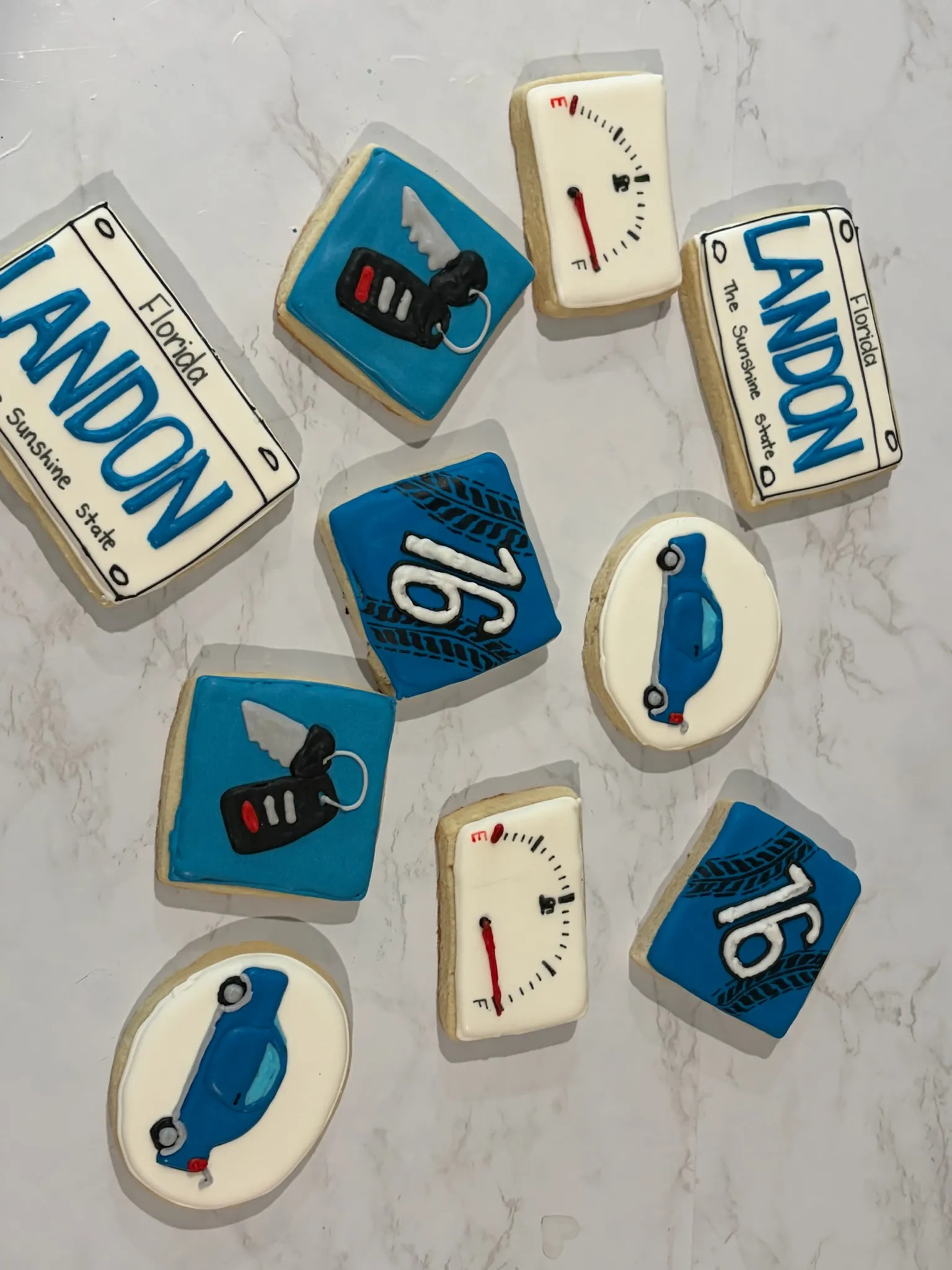 License-plate cookies iced with a name and the number sixteen