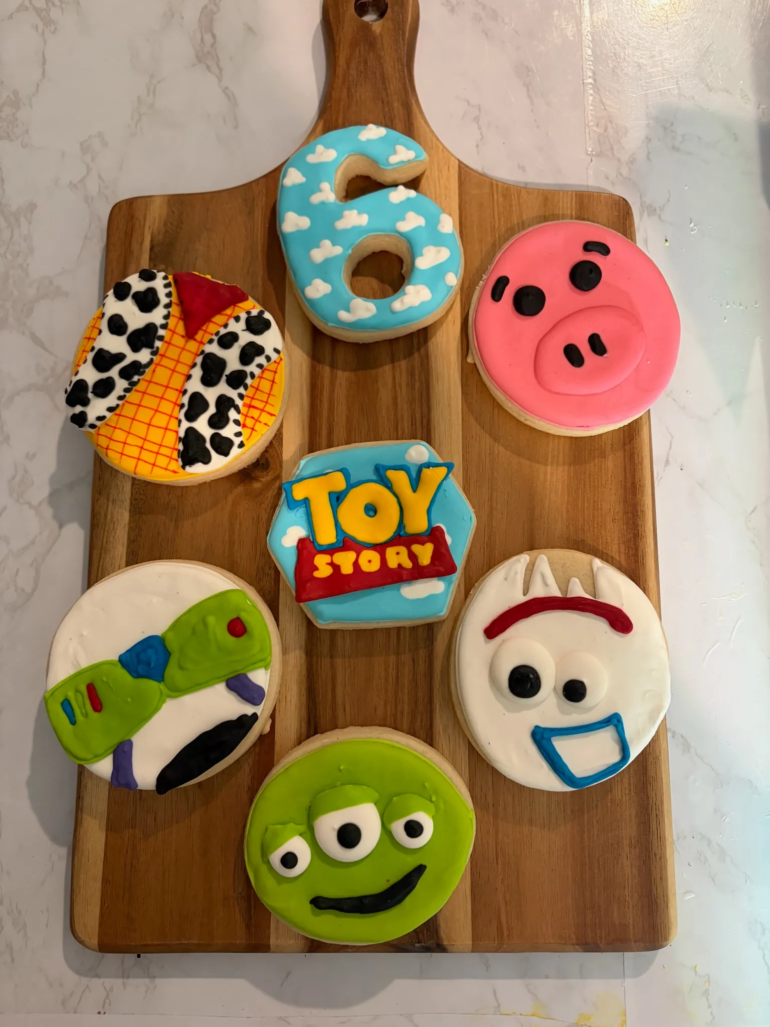 Toy Story face cookies including Rex, Woody and the alien