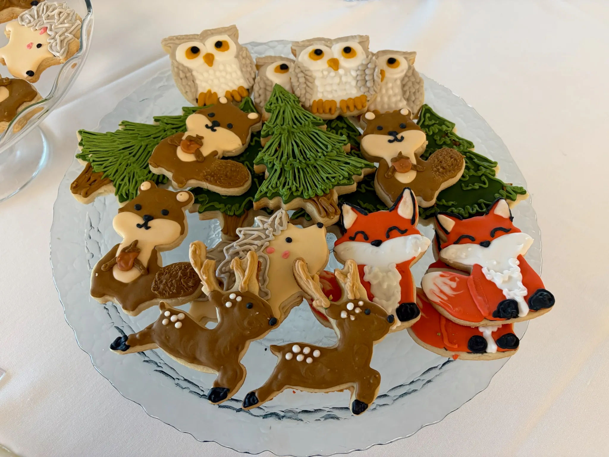Woodland-themed decorated sugar cookies: deer, foxes, owls and pine trees