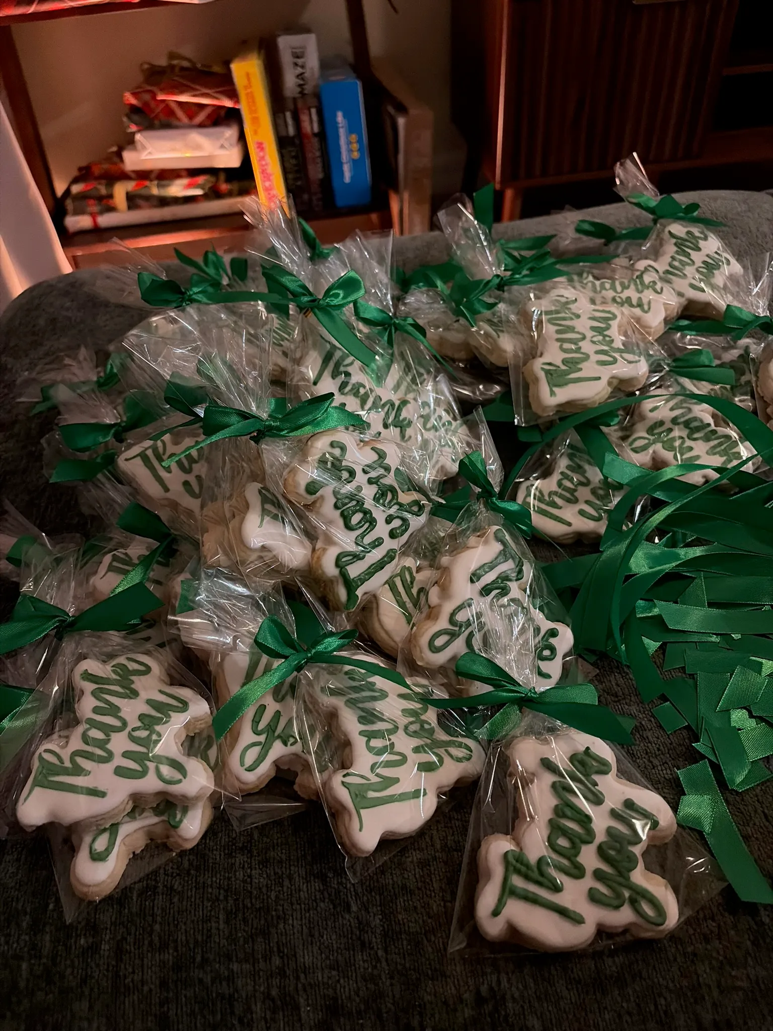 Individually wrapped cookies tied with green ribbon as party favors