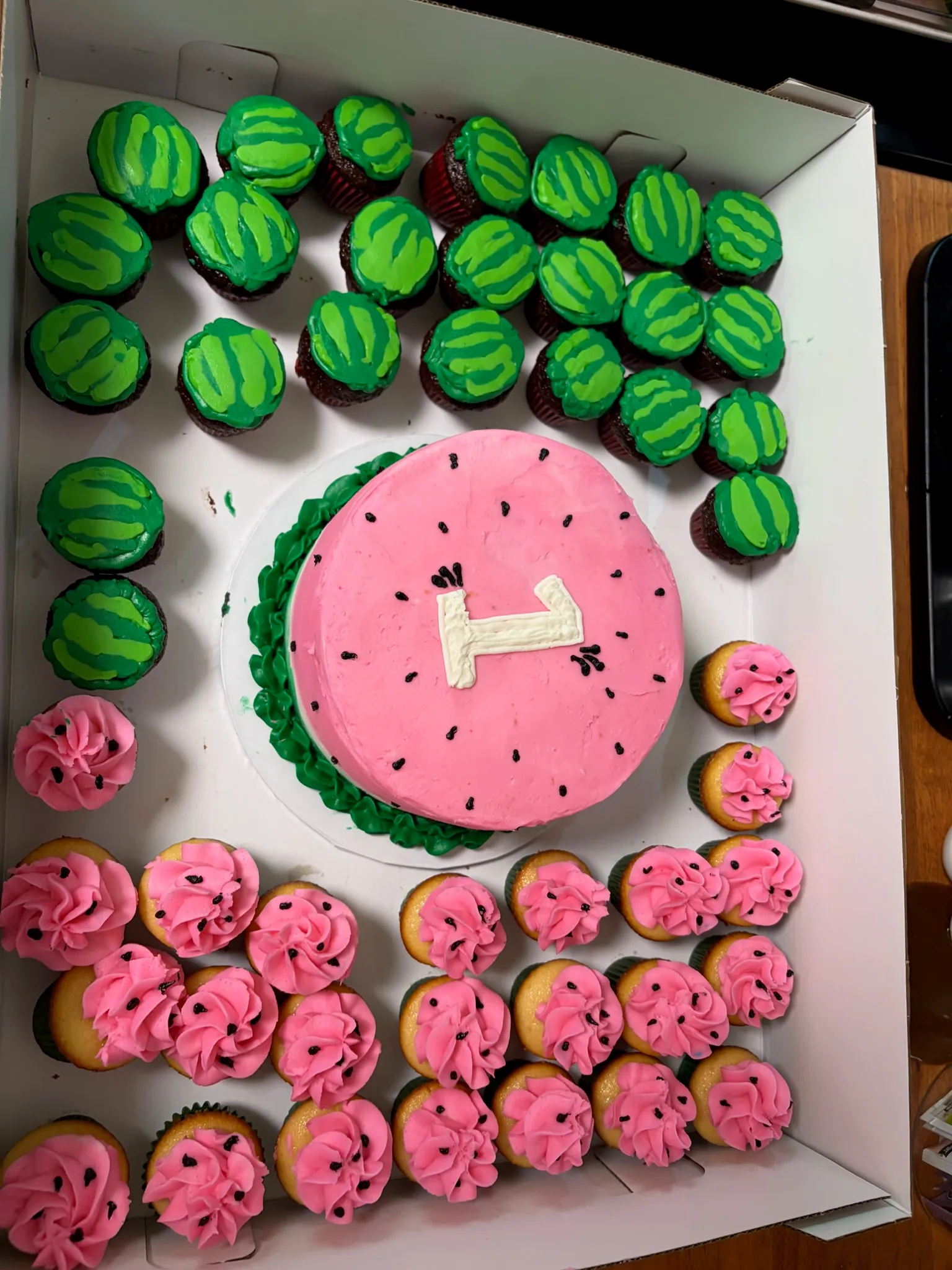 A themed dessert table with a cake, cookies and cupcakes