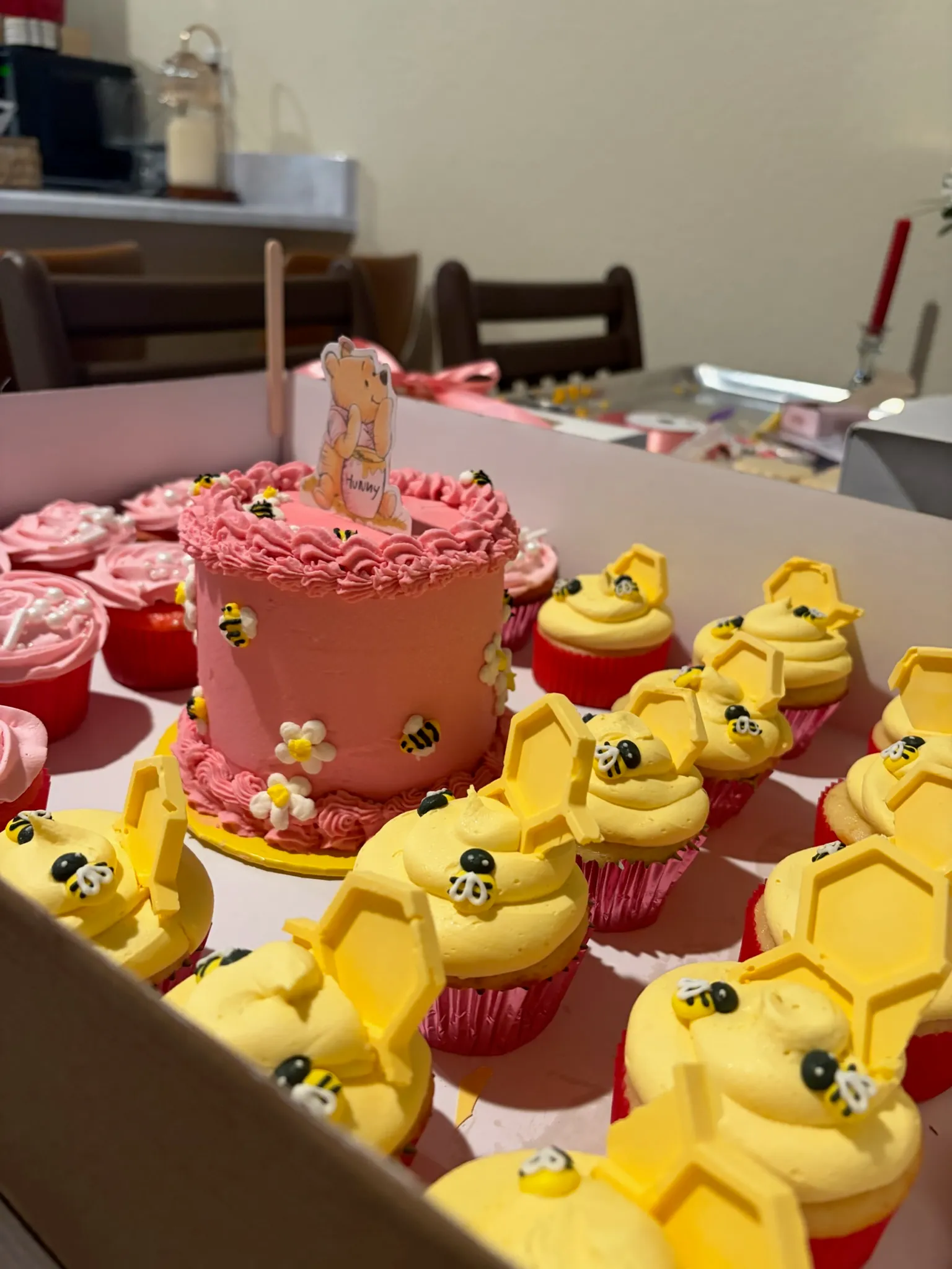 A duckling-themed dessert spread with a cake and cake pops
