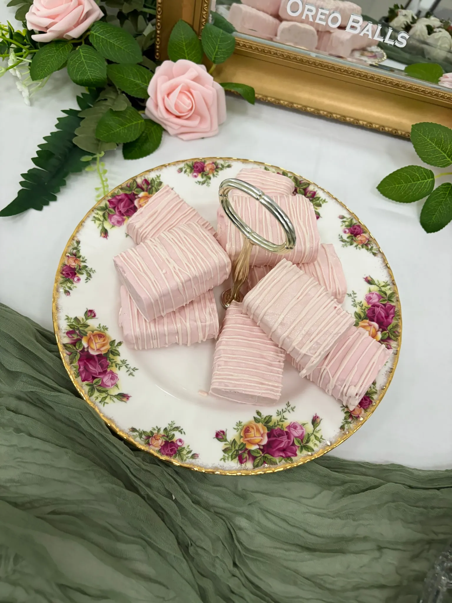 Pink-dipped treats on a gold-rimmed floral china plate