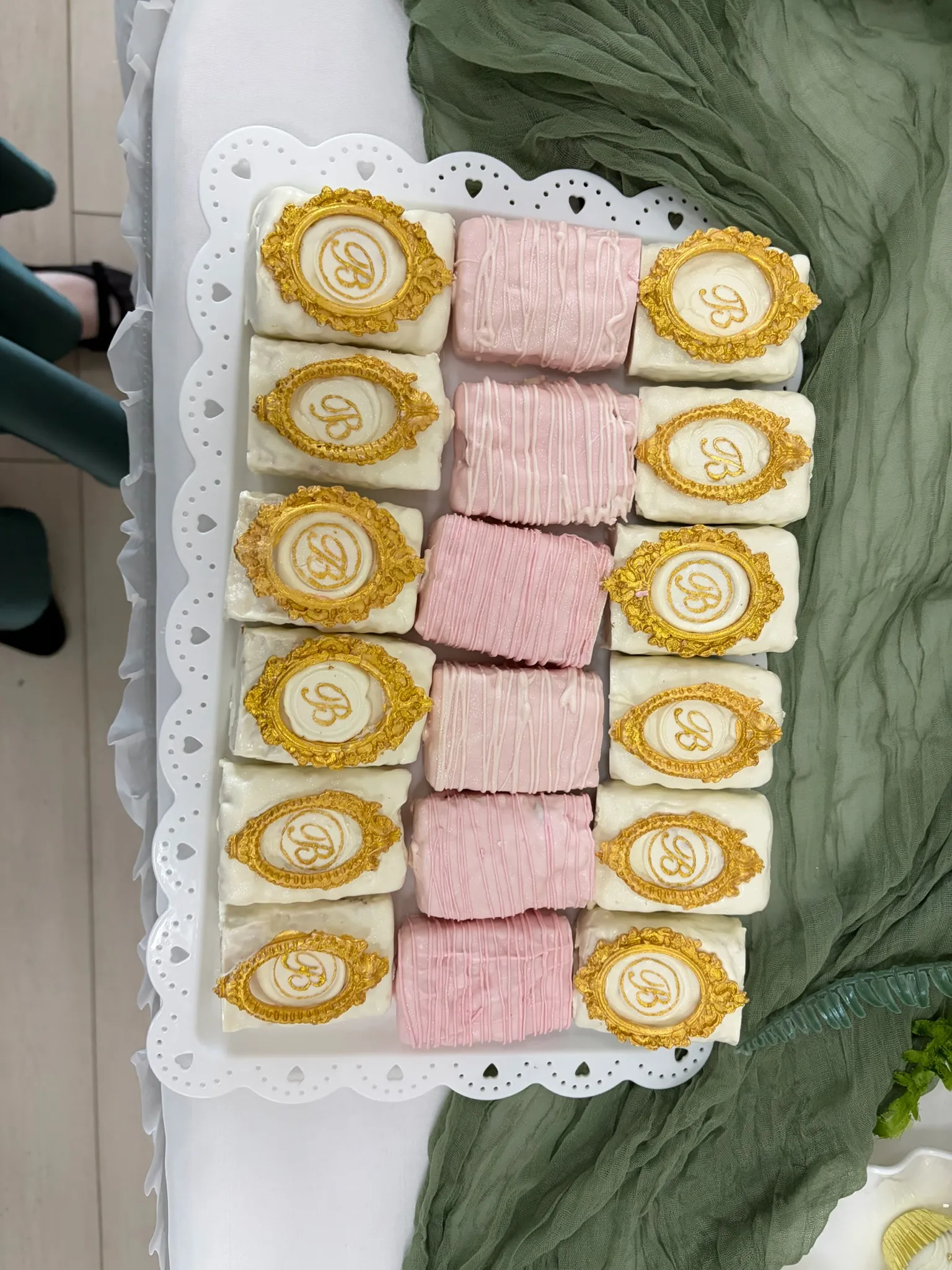 Pink and gold wrapped treats set out on a serving tray